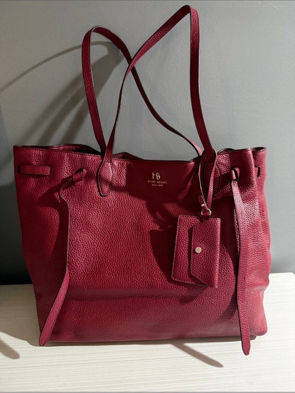 Henri Bendel tote bag features pebbled leather and gold-toned hardware.
